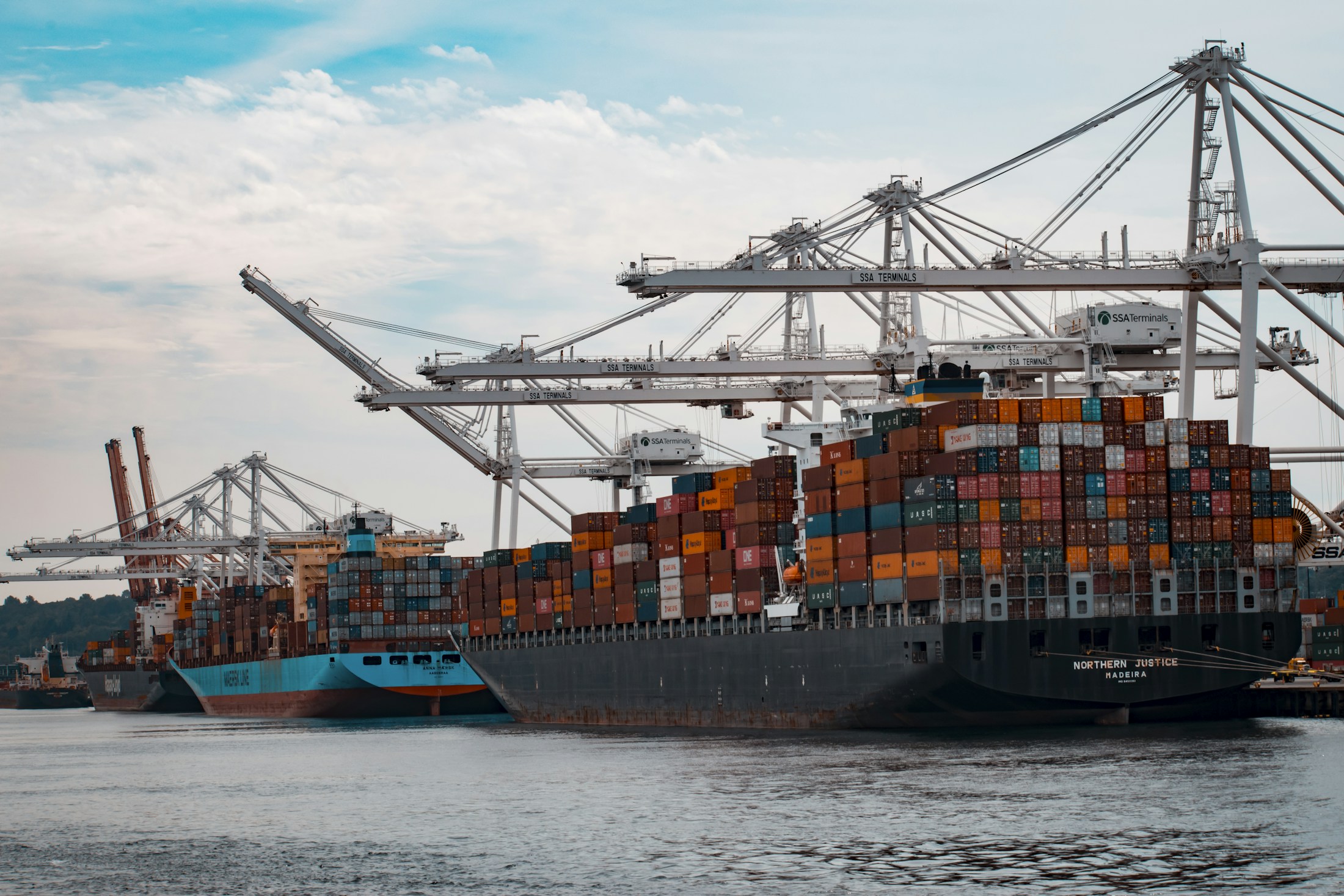 Container ship alongside cargo port cranes